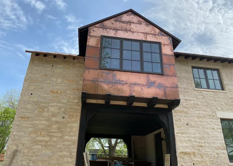 Copper metal panel facade on a stone building for Skylight Installation in Union Grove