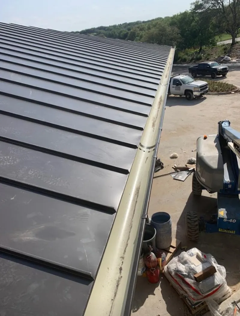 Standing seam panel and gutter detail on a metal roofing jobsite in Union Grove